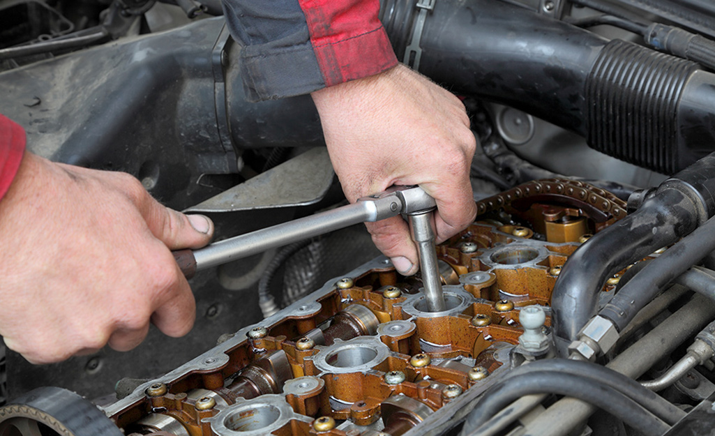 An automotive technician changing spark plugs