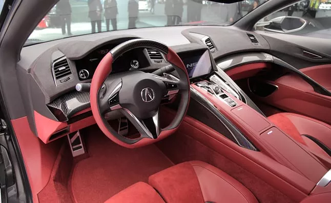 Acura interior with red leather seats and carbon fiber trim
