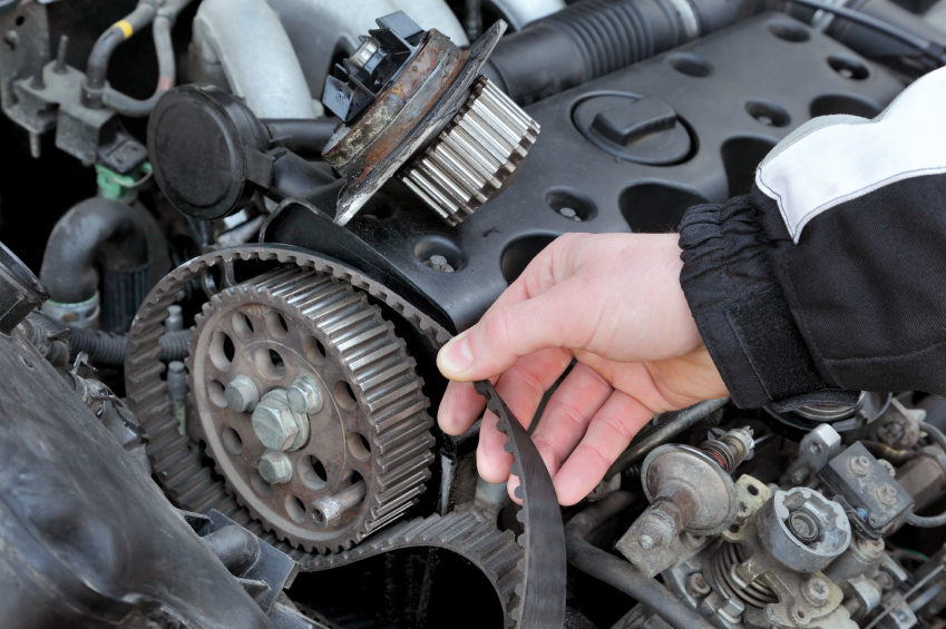 Removed Acura timing belt held beside the engine block and water pump during timing belt service