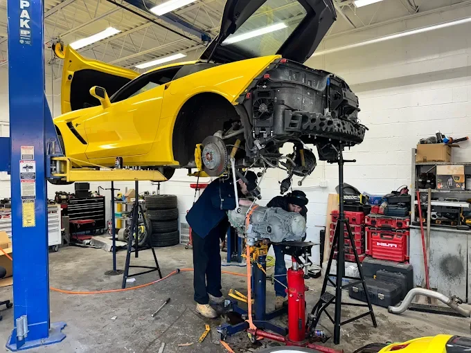 Beach Auto Repair technician servicing a transmission on a lifted sports car in our Virginia Beach shop