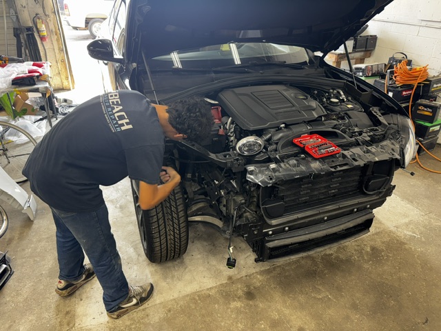 Beach Auto Repair technician servicing a Land Rover engine in our Virginia Beach shop