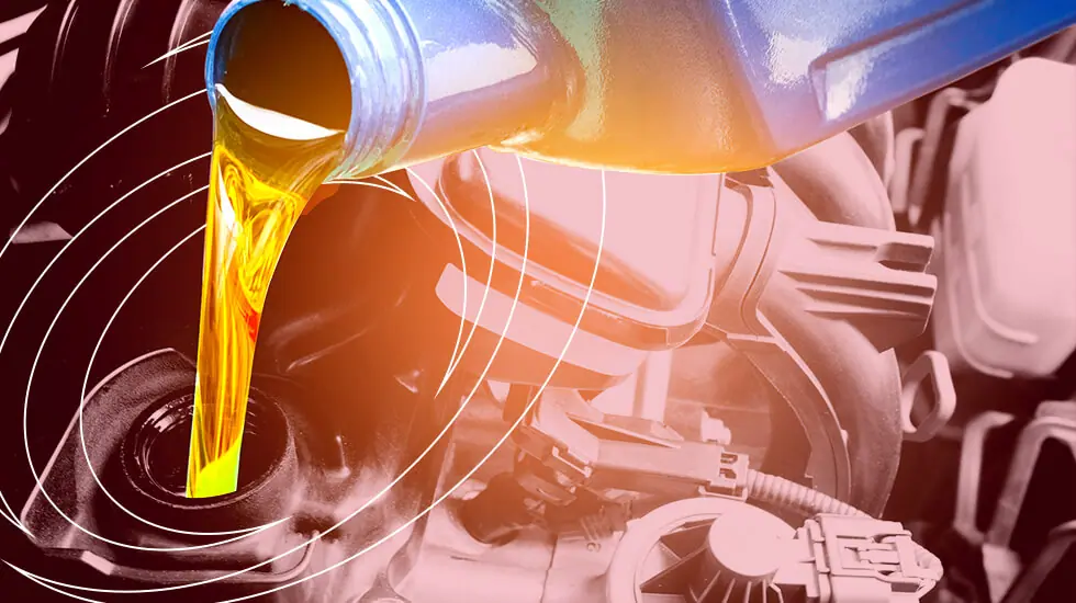 Closeup of oil pouring into a vehicle