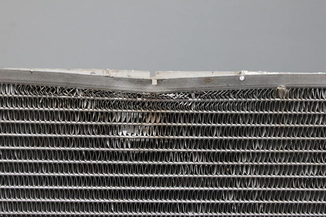 Closeup of a radiator showing bent fins