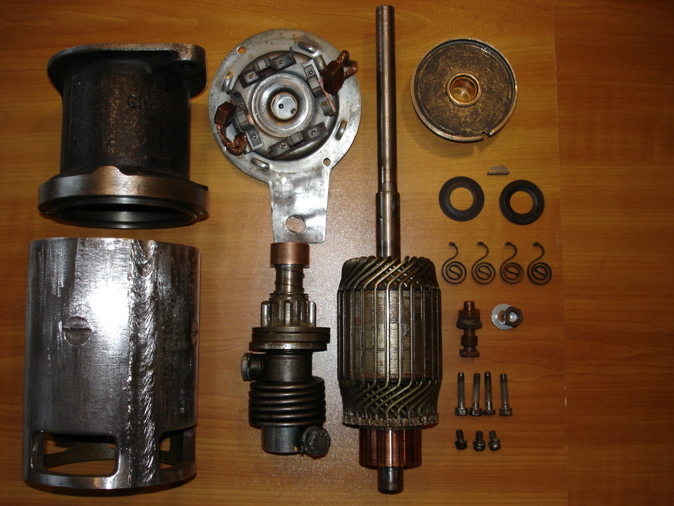 The individual parts of a starter laid out on a table