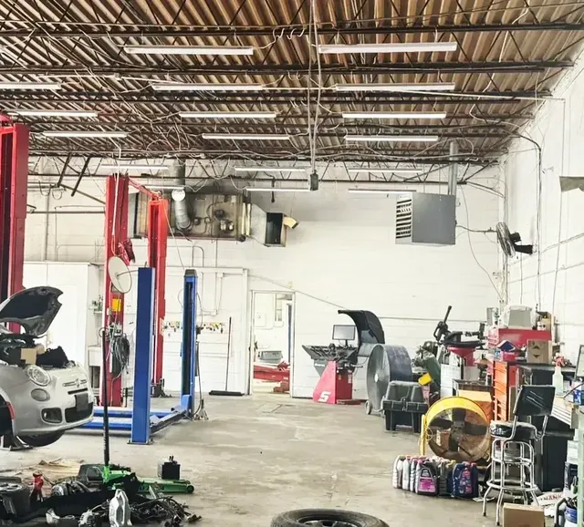 Service bays with vehicle lifts and repair equipment inside Beach Auto & Transmission Repair in Virginia Beach