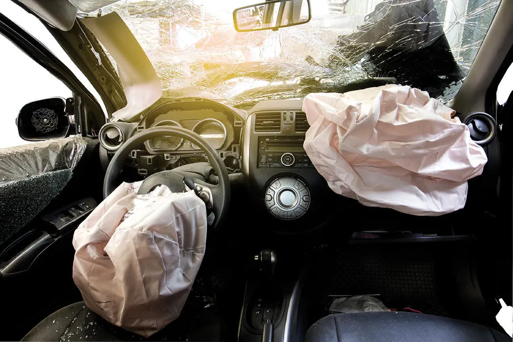 Technician inspecting a vehicle airbag module and SRS system during a safety diagnostic