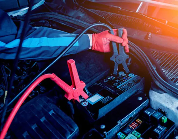 Car battery and electrical system being tested with diagnostic equipment at Beach Auto Repair