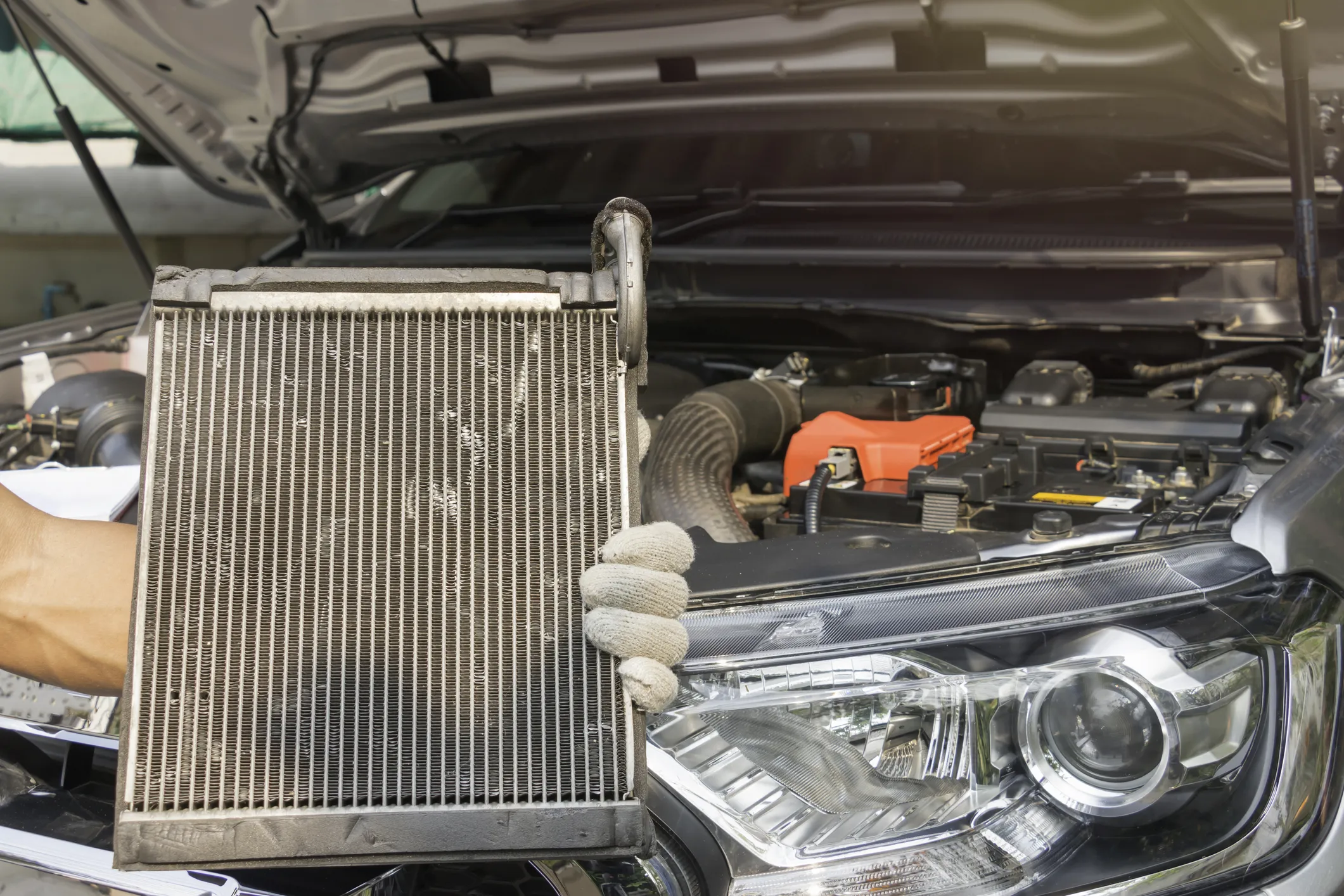 Radiator and cooling system components being serviced to prevent engine overheating