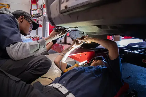 Certified technician performing a Virginia state safety inspection on a vehicle