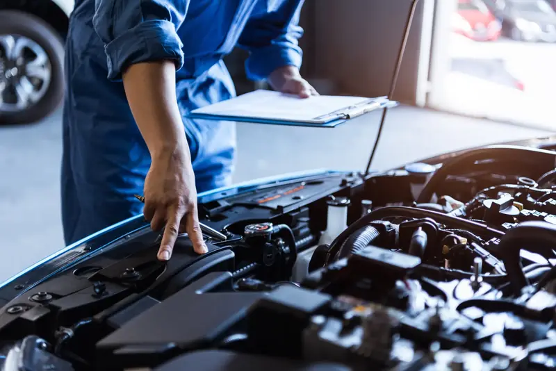 Mechanic using a torque wrench to service an engine during a tune up at Beach Auto Repair